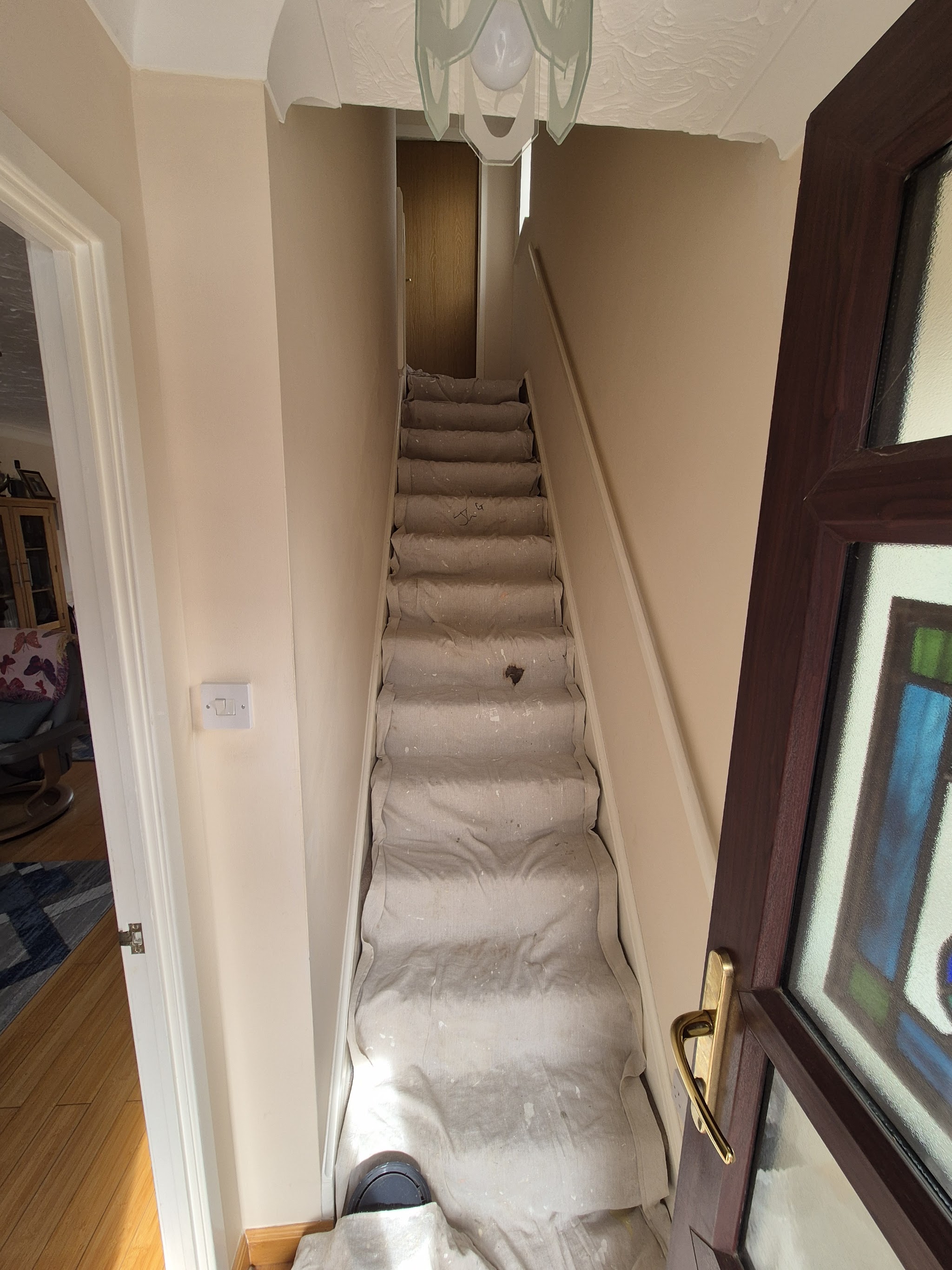 Hallway and staircase with dust sheets down, ready for decorating