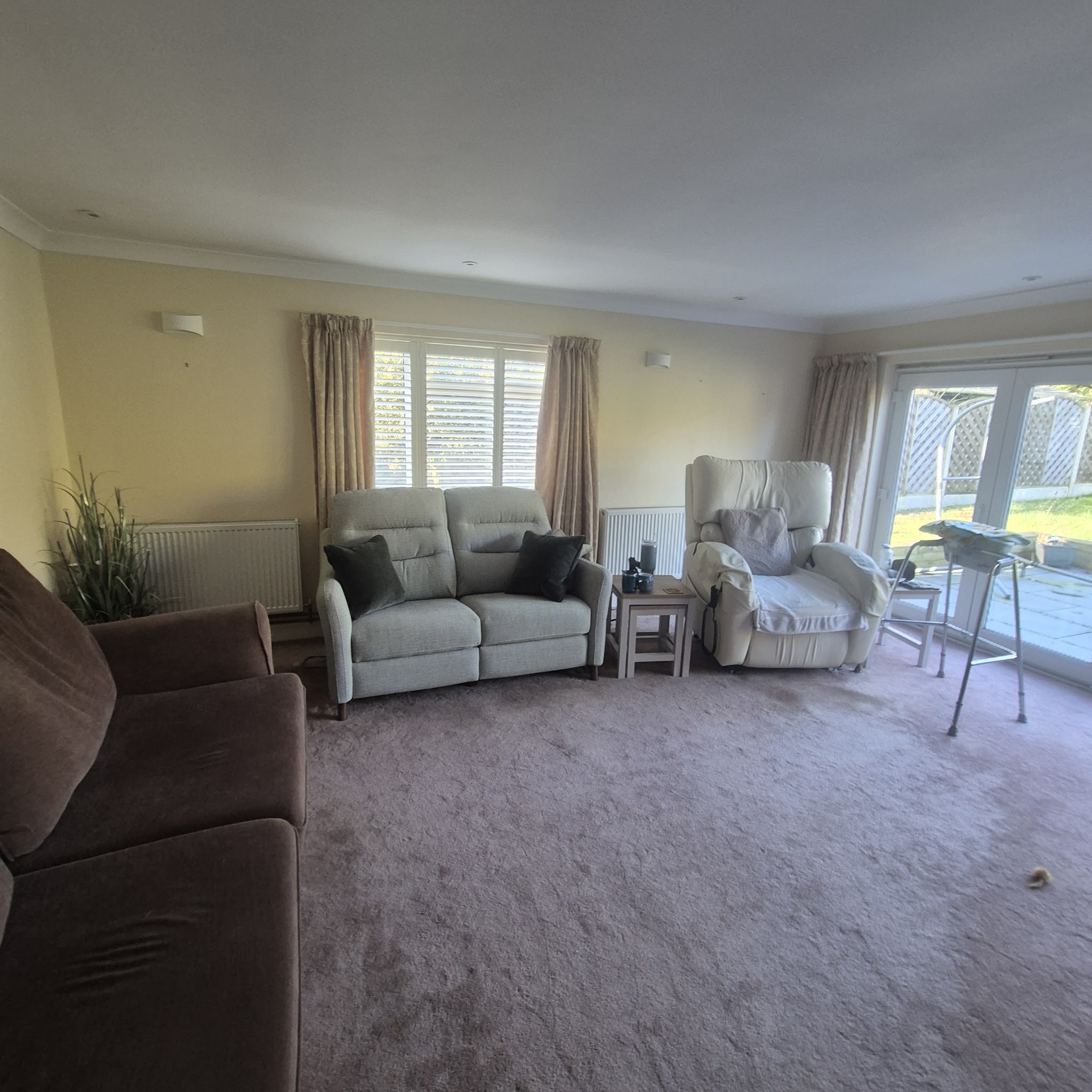Bright, freshly decorated lounge with plantation shutters